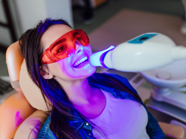 Teeth whitening for woman. Bleaching of the teeth at modern dentist clinic.
